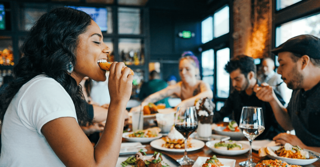 Group of people eating food at a restaurant